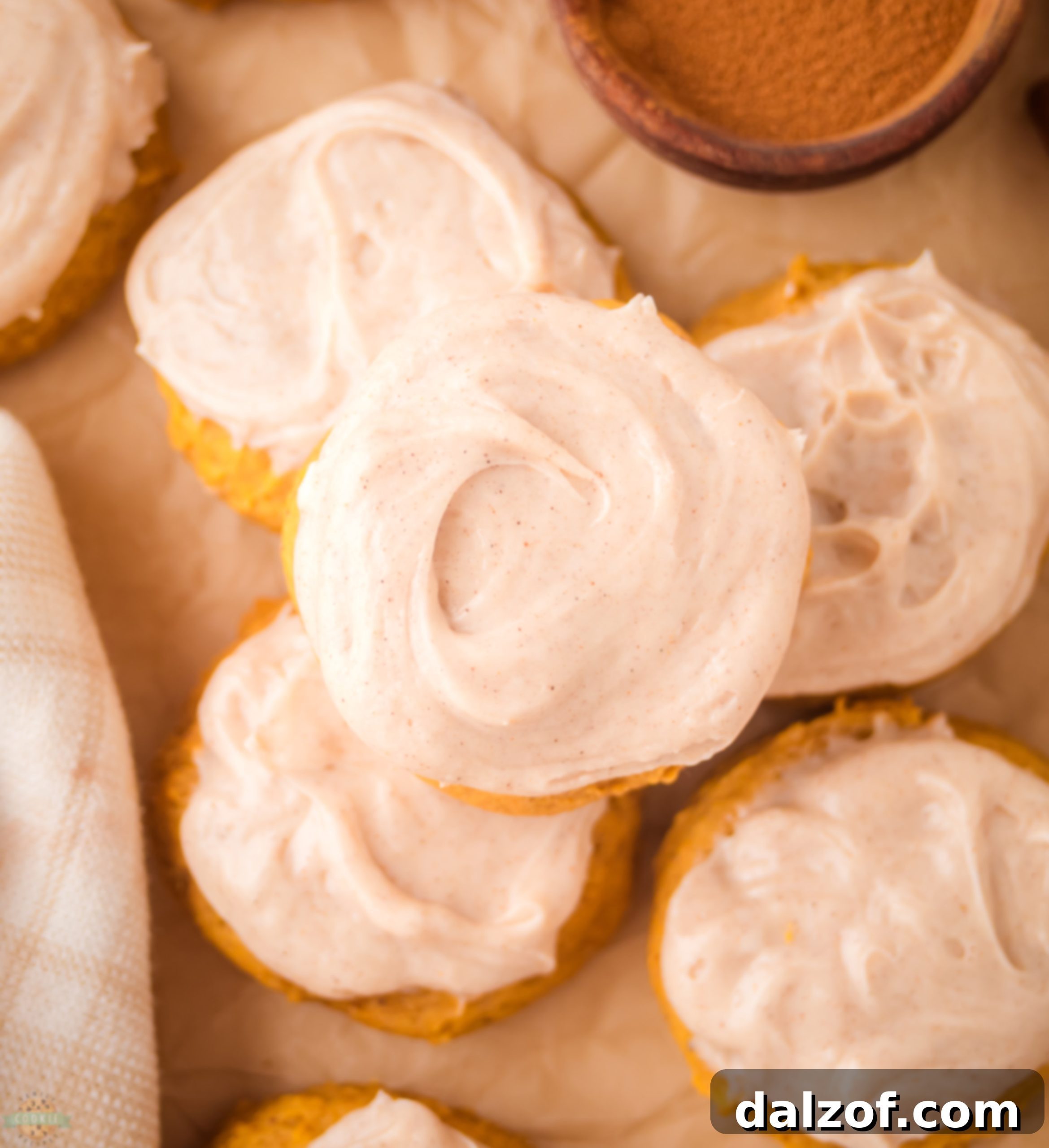 pile of frosted pumpkin cookies