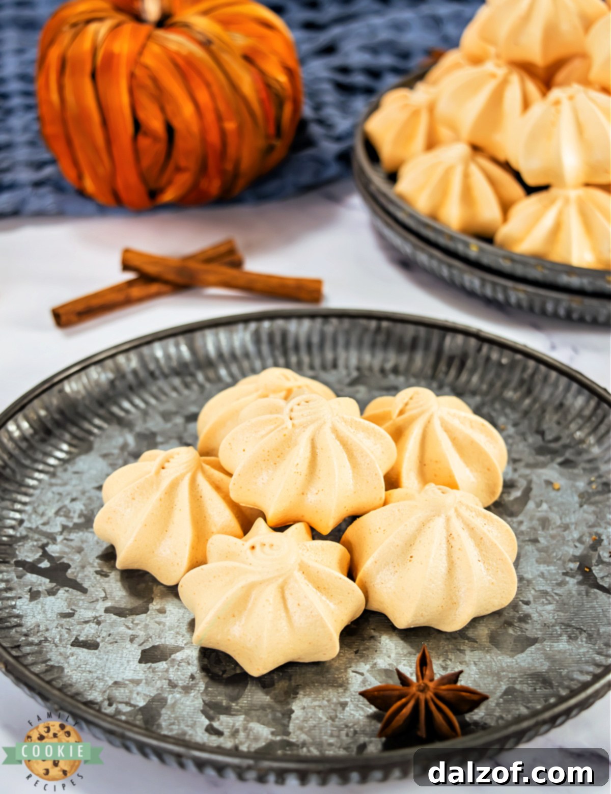 Close-up of piped meringues with crisp ridges and glossy finish.