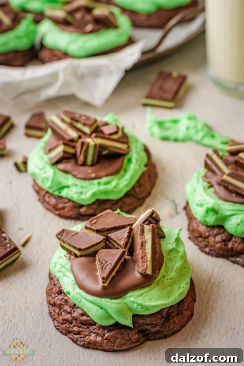 Piping mint frosting onto cooled Grasshopper Cookies