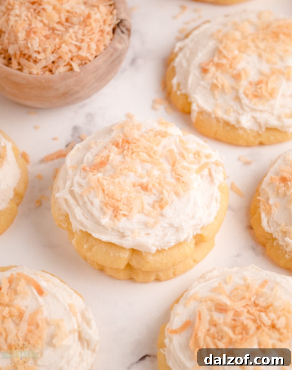 Frosted coconut sugar cookies cooling on a rack