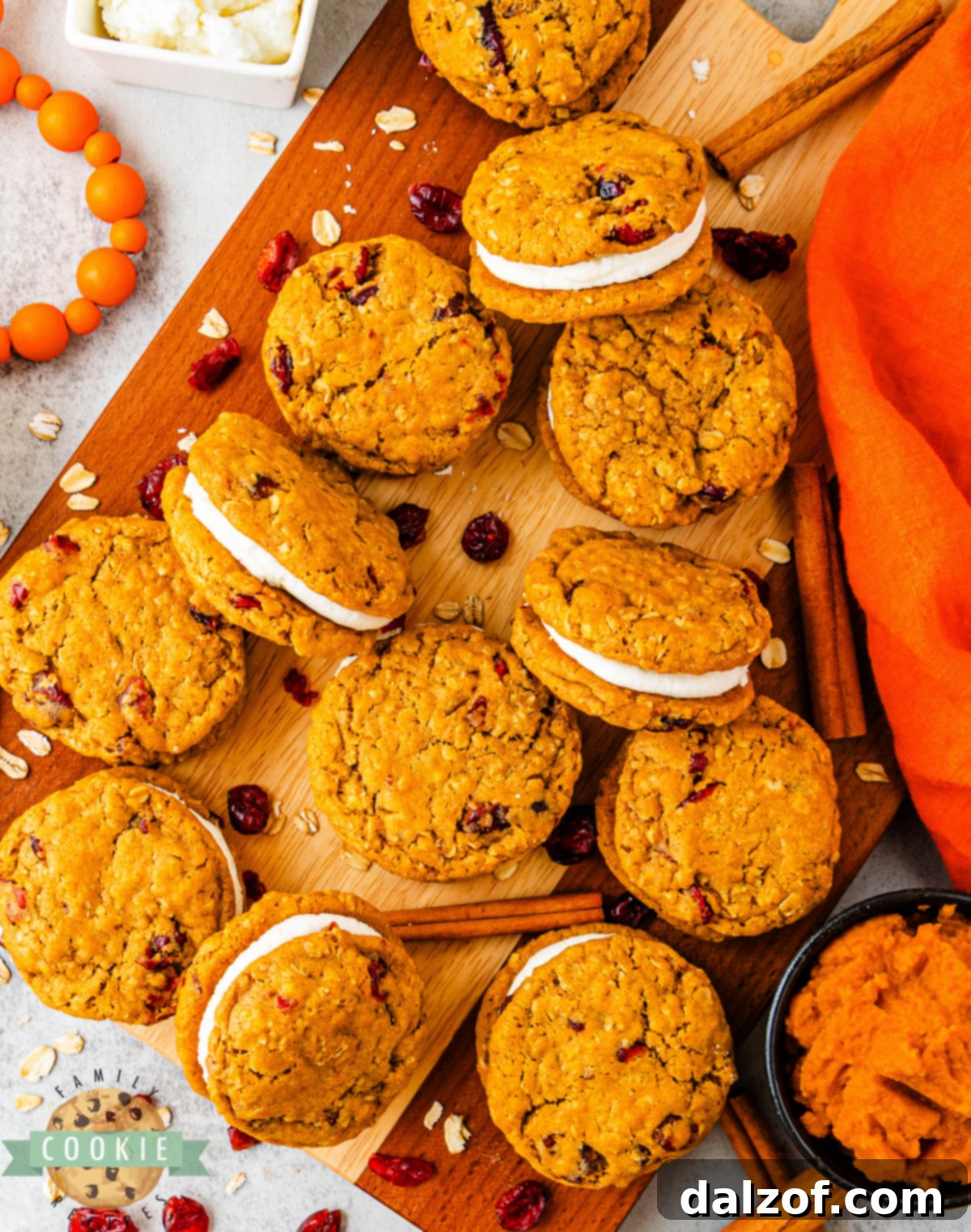 Pumpkin oatmeal sandwich cookies showing soft centers and creamy frosting between layers.