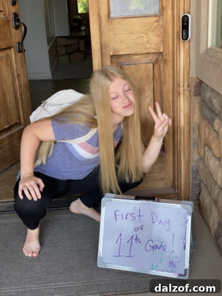 Teenager posing for a first day of school photo, showing personality and humor.