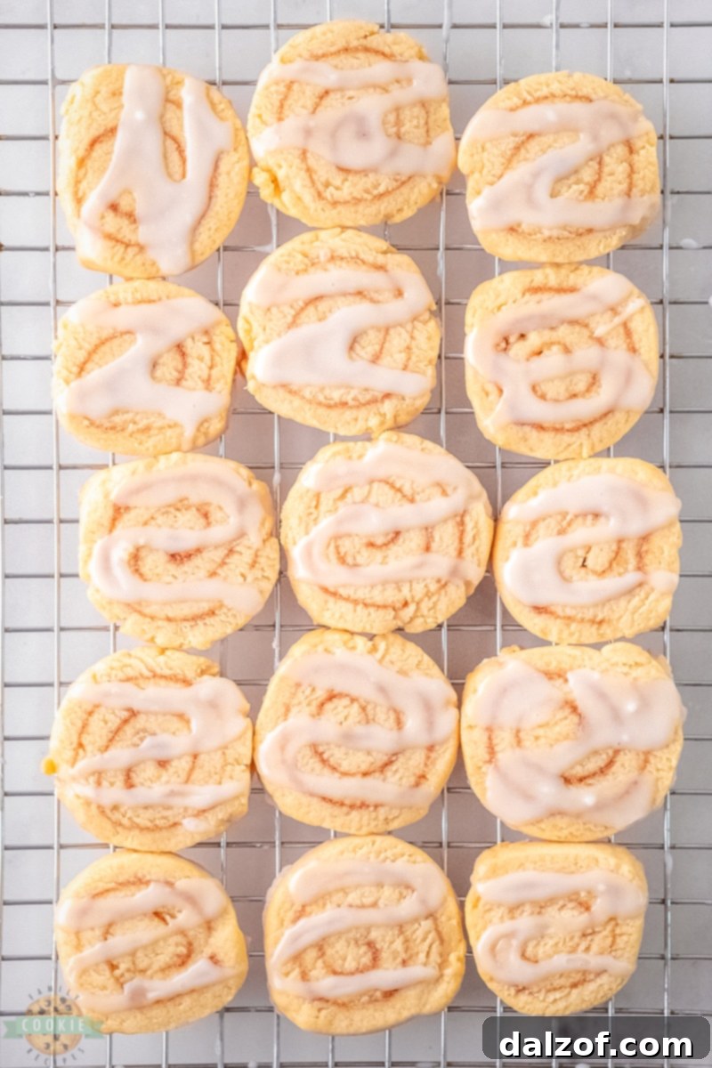 Close-up of cinnamon roll cookie dough being prepared, showing the soft, golden dough on a parchment paper.