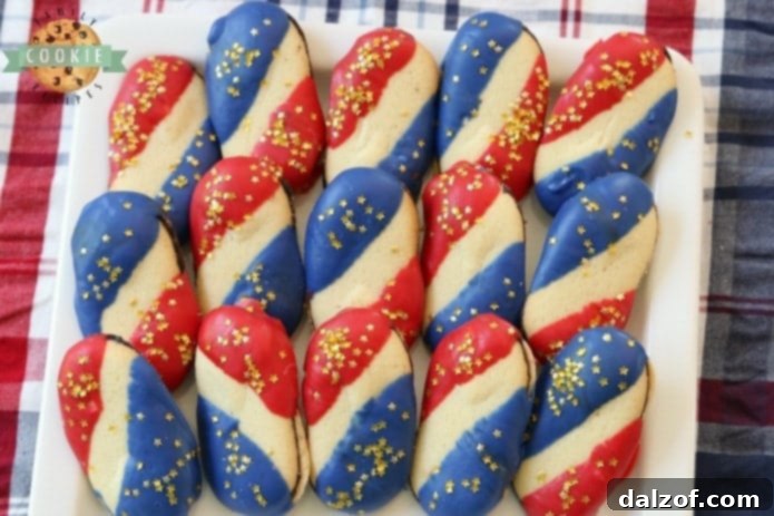 Super Simple 4th of July Cookies made with just 4 ingredients and NO BAKE! Easy red, white and blue cookies made with Milano cookies dipped in red and blue melting chocolate then sprinkled with gold stars. Made in just 15 minutes and they're perfectly patriotic!
