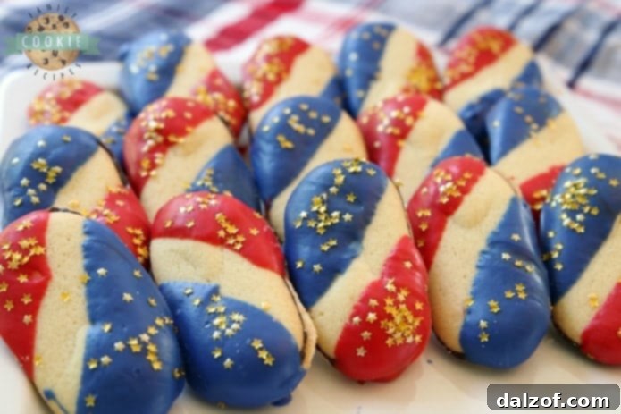 Super Simple 4th of July Cookies made with just 4 ingredients and NO BAKE! Easy red, white and blue cookies made with Milano cookies dipped in red and blue melting chocolate then sprinkled with gold stars. Made in just 15 minutes and they're perfectly patriotic!