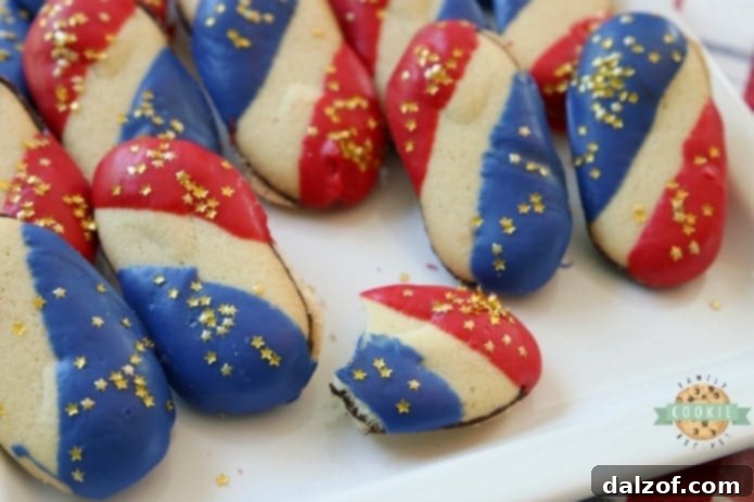 Super Simple 4th of July Cookies made with just 4 ingredients and NO BAKE! Easy red, white and blue cookies made with Milano cookies dipped in red and blue melting chocolate then sprinkled with gold stars. Made in just 15 minutes and they're perfectly patriotic! #4thofJuly #patriotic #cookies #redwhiteandblue #cookie #recipe #simple Recipe from FAMILY COOKIE RECIPES