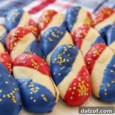 Super Simple 4th of July Cookies made with just 4 ingredients and NO BAKE! Easy red, white and blue cookies made with Milano cookies dipped in red and blue melting chocolate then sprinkled with gold stars. Made in just 15 minutes and they're perfectly patriotic!
