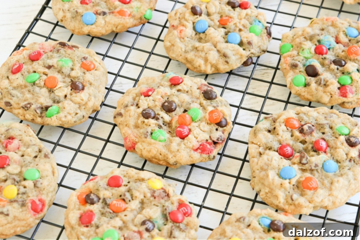 M&M Oatmeal Cookies with a sprinkle of M&Ms on top, arranged on a rustic wooden surface.