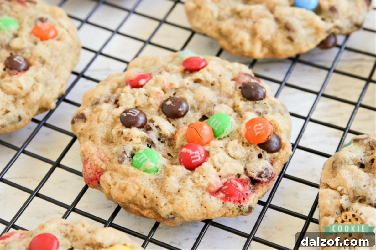 Several M&M Oatmeal Cookies stacked and scattered, showing the delicious texture.