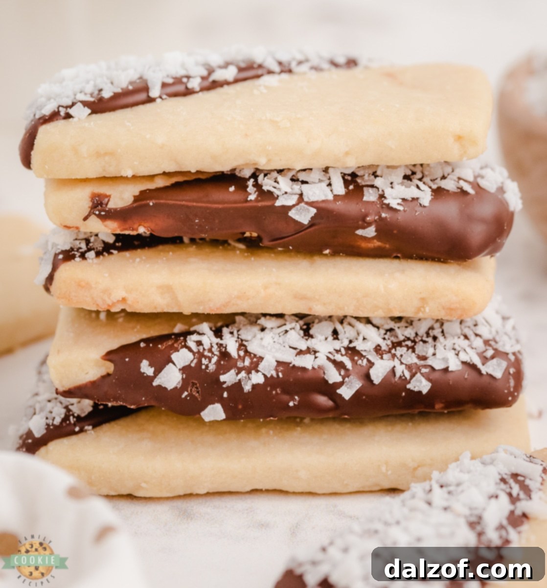 stacked coconut shortbread cookies that were dipped in chocolate