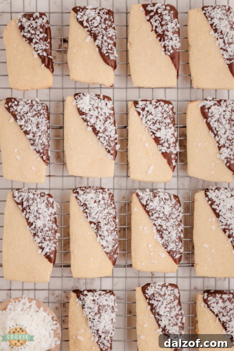 chocolate dipped coconut shortbread cookies on a cooling rack