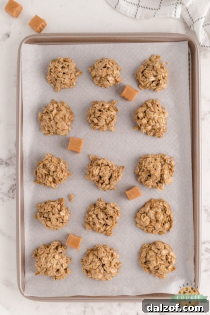 A batch of finished Caramel Oatmeal No Bake Cookies on a white plate, highlighting their inviting golden-brown color and chewy texture.