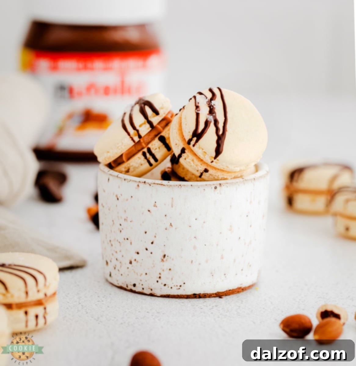 Close-up of perfectly baked Nutella macarons showcasing their delicate feet