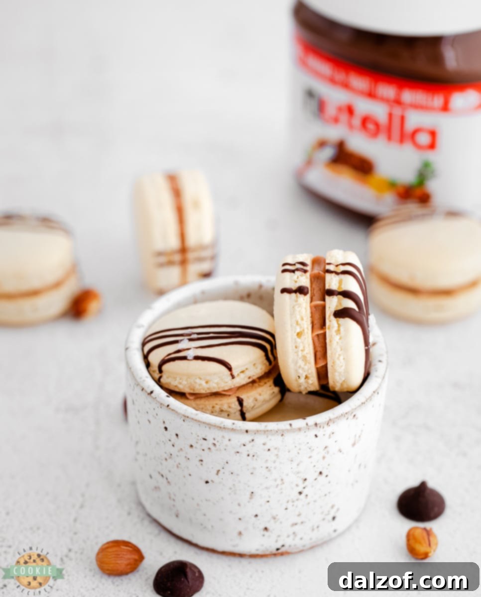 Nutella buttercream being piped onto macaron shells