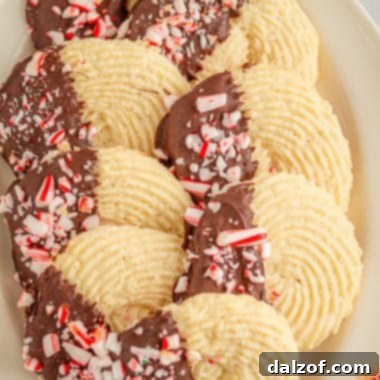 Peppermint Butter Cookies with festive chocolate and candy cane topping