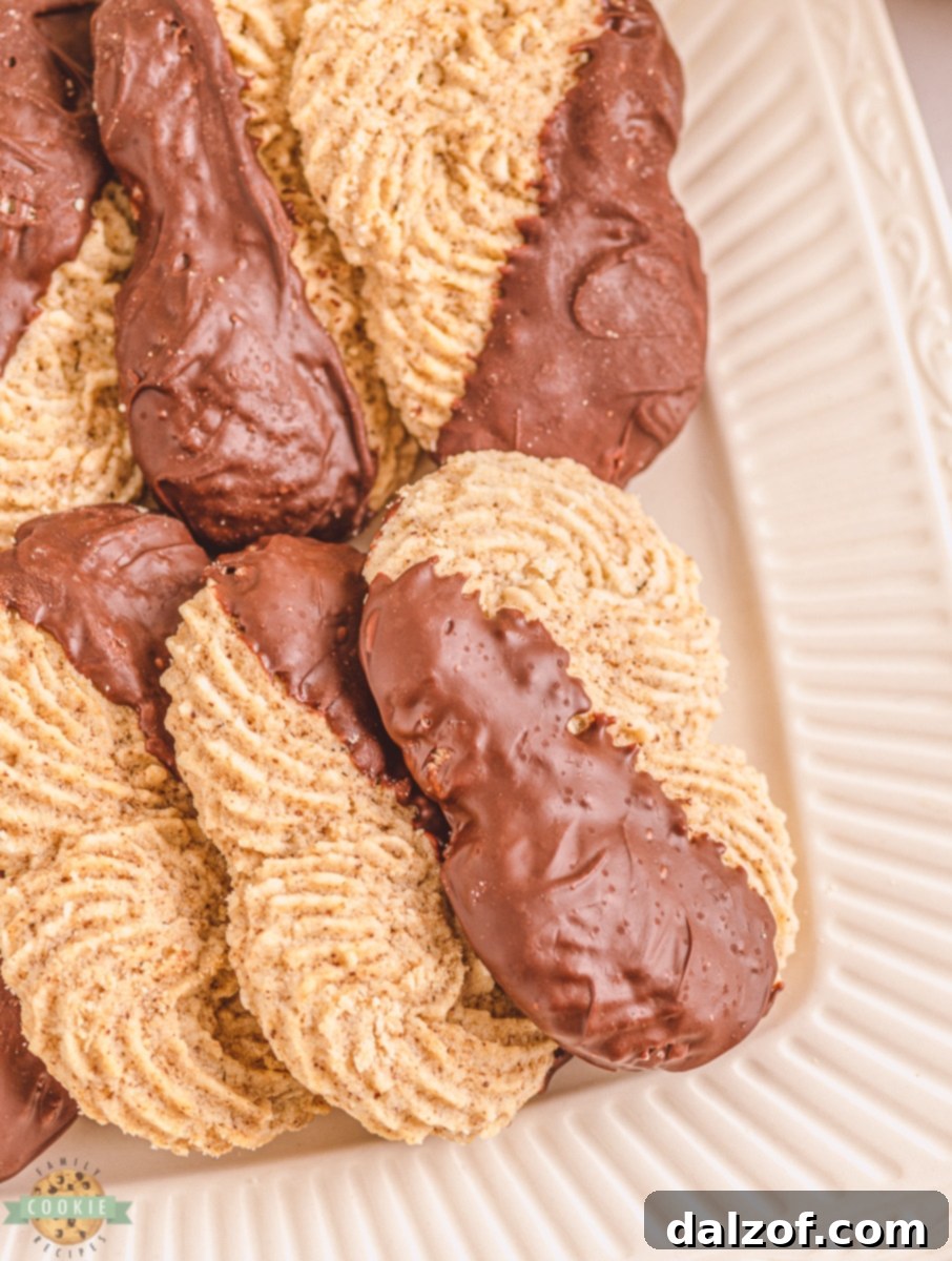 Close-up of baked espresso butter cookies before chocolate dipping, showing their intricate shape.
