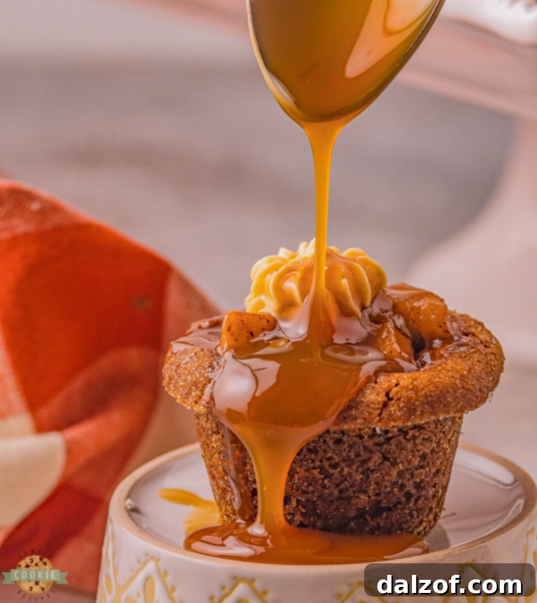 Close-up of caramel apple gingerbread cookies in mini muffin cups, topped with frosting and caramel drizzle, ready to be served