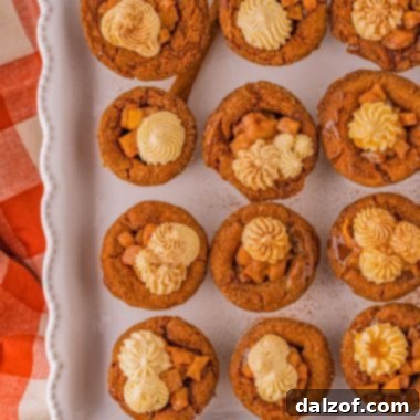 A beautifully decorated Caramel Apple Gingerbread Cookie with frosting and caramel drizzle