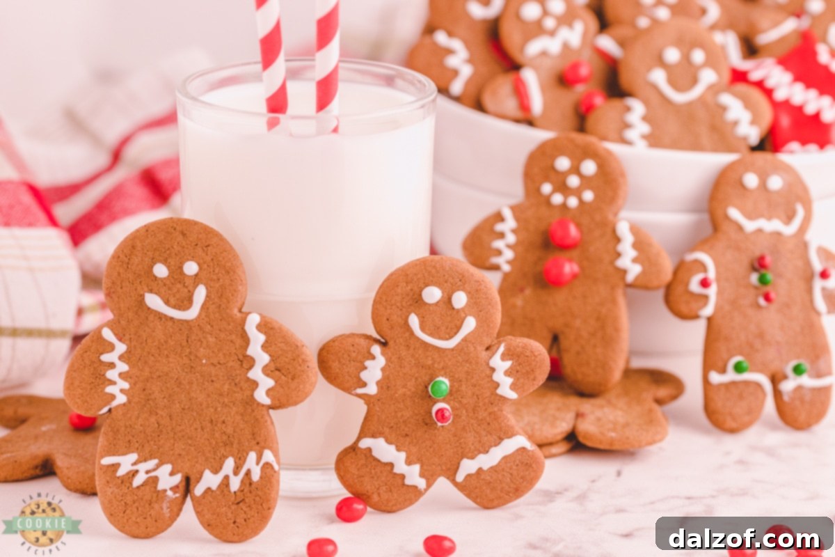 Classic gingerbread cut-out cookies served with a glass of milk, perfect for holiday treats.