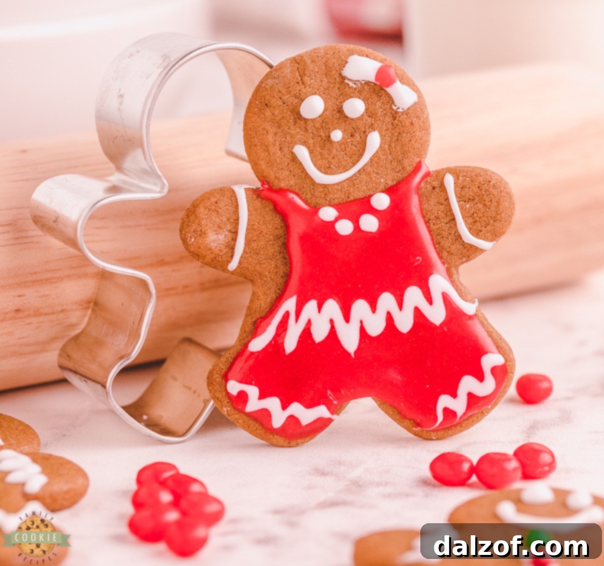 Gingerbread girl cookie next to a classic gingerbread cookie cutter, highlighting the festive baking process.