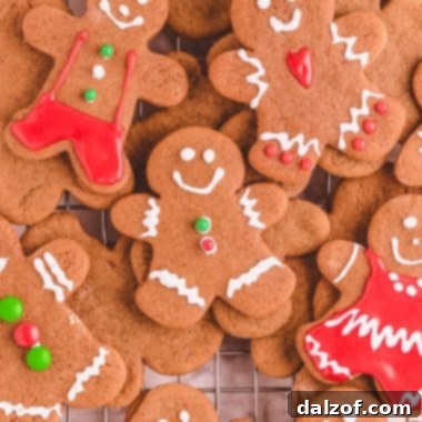 decorated gingerbread cookies piled on a cooling rack