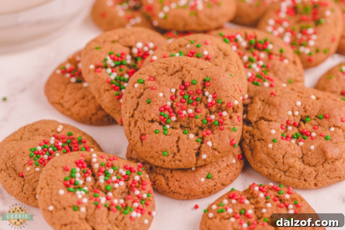 A festive spread of perfectly baked mini gingerbread cookies, adorned with colorful holiday sprinkles, ready for Christmas celebrations.
