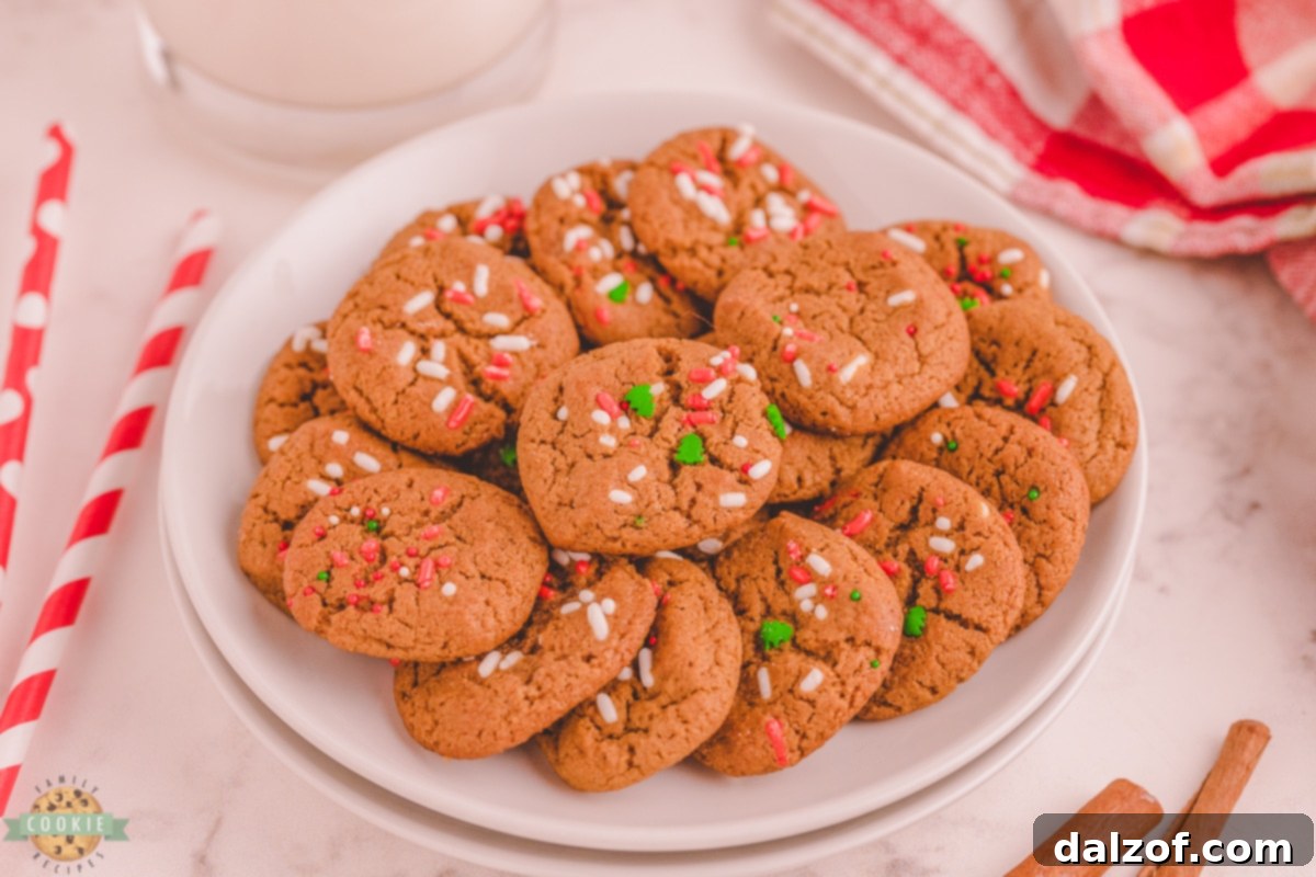 Close-up of golden-brown mini gingerbread cookies, some with festive sprinkles, showcasing their perfect two-bite size and inviting texture.