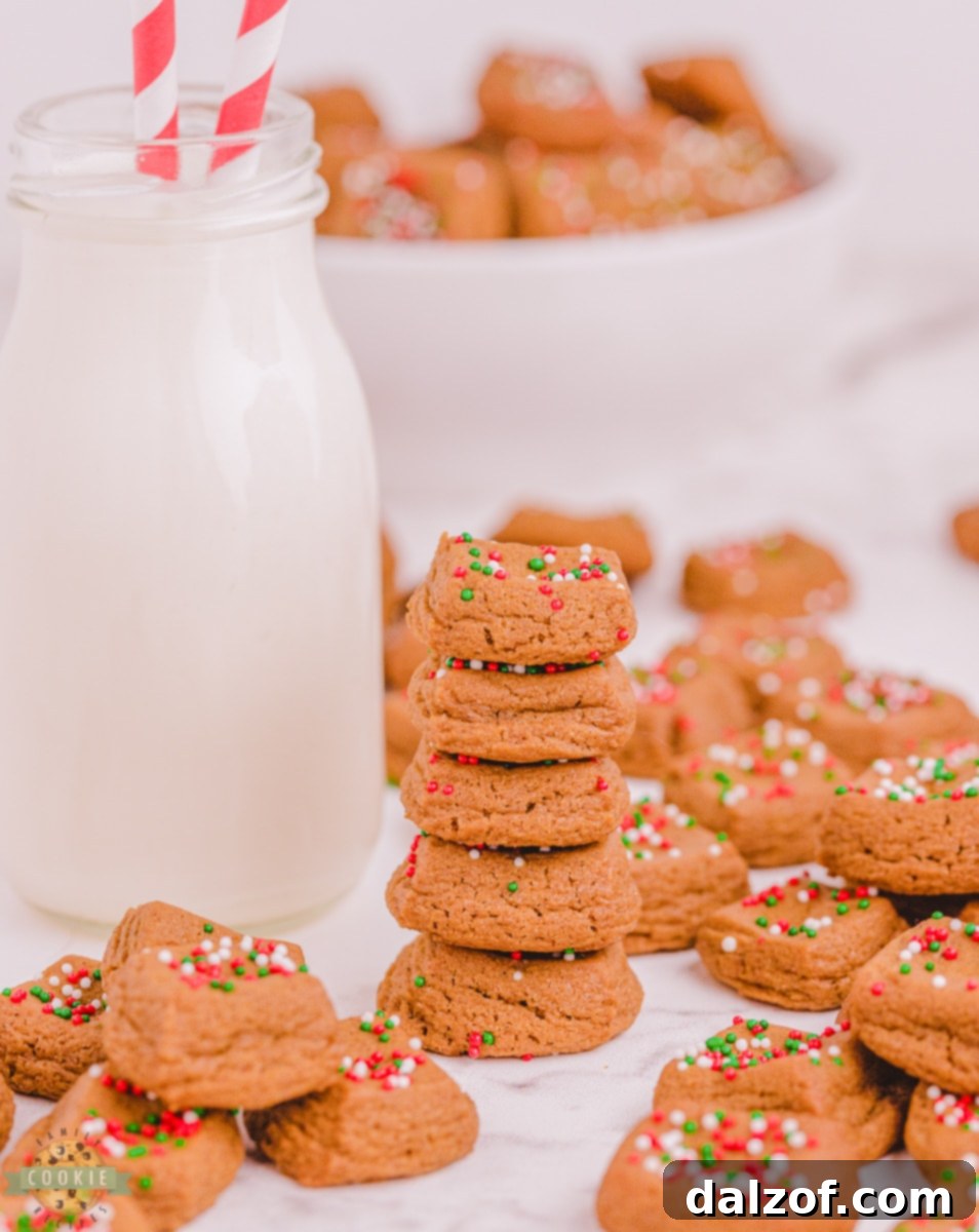 A tray filled with freshly baked Christmas Gingerbread Cookie Bites, showcasing their perfect cube shape and festive sprinkles.
