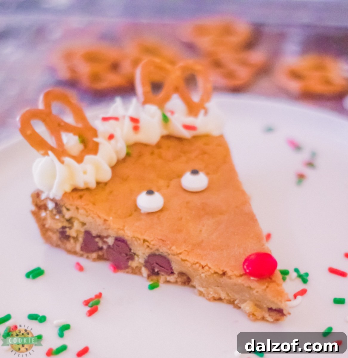 Close-up of chocolate chip cookie dough being pressed into a springform pan.