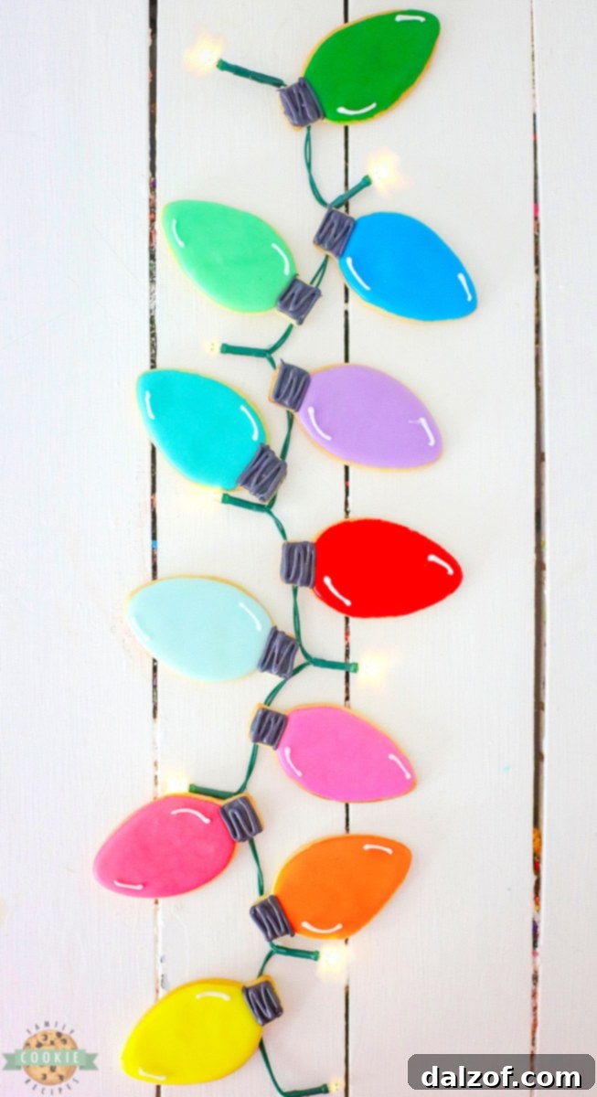 Close-up of a hand decorating a Christmas Light Cut-Out Cookie with icing