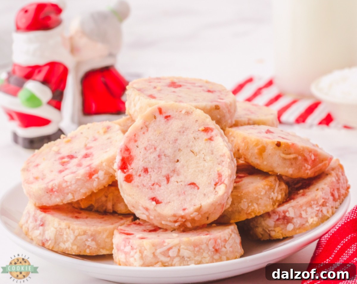 Santa's Whiskers Cookies featuring a buttery texture, sweet cherries, pecans, and rolled in coconut for a classic festive look.
