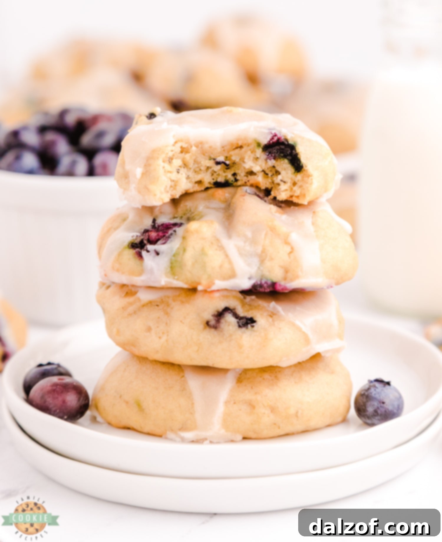 stack of blueberry banana cookies on a plate, showing their soft texture and glaze