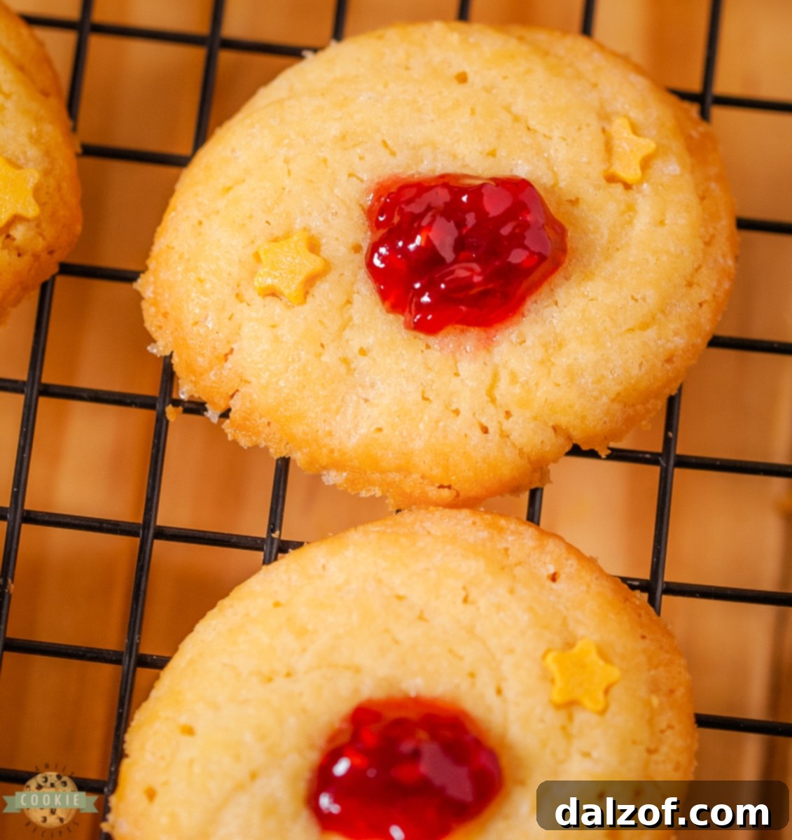 An assortment of classic Danish butter cookie shapes, including rounds, rings, and piped swirls, arranged artfully on a white surface, ready for baking or serving.