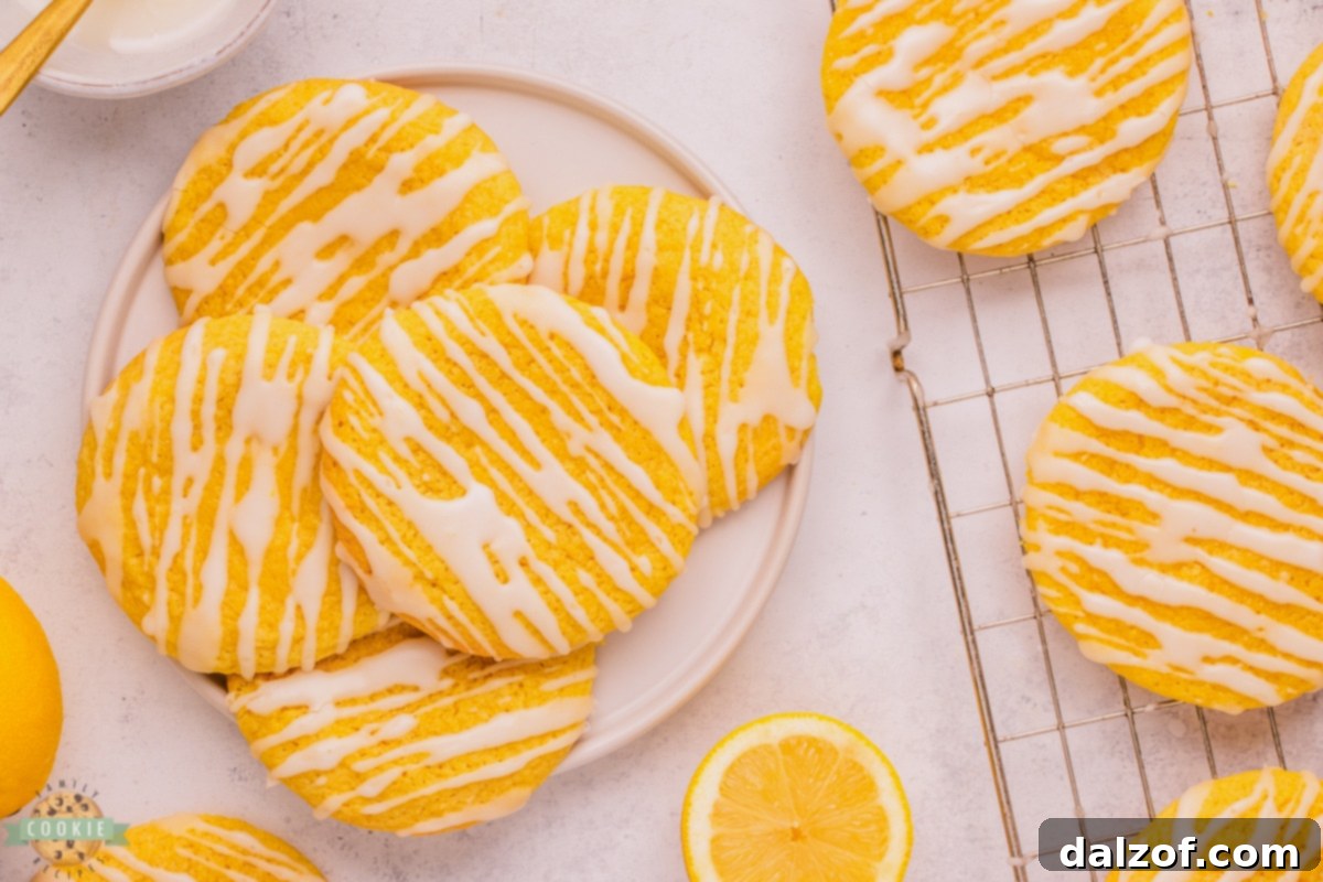 Close-up of a soft glazed lemon cookie, showcasing its perfect texture and shiny glaze.