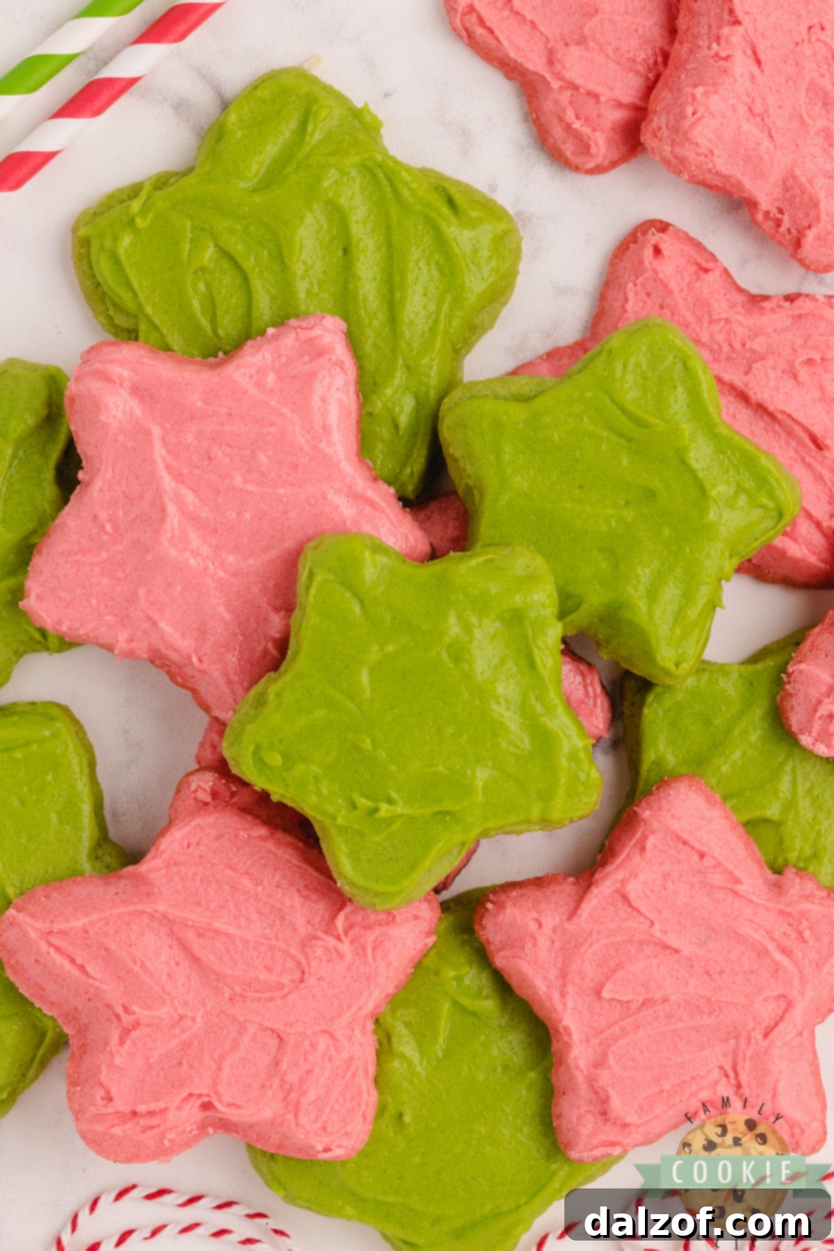 Cut-out sugar cookies made with red and green Jello for Christmas, beautifully decorated