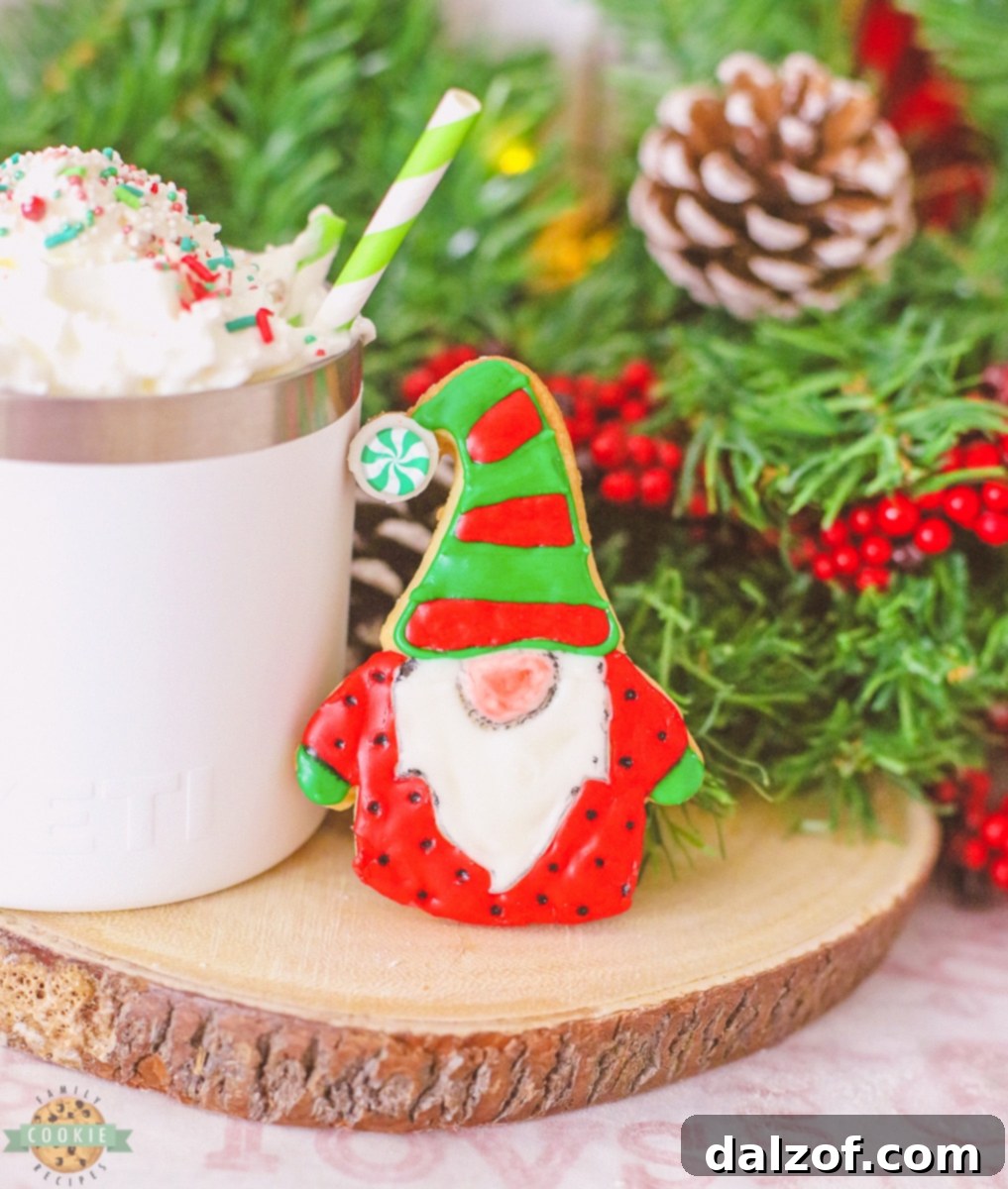 iced gnome cookies arranged neatly on a cooling rack, showcasing various stages of decoration with red and green icing.