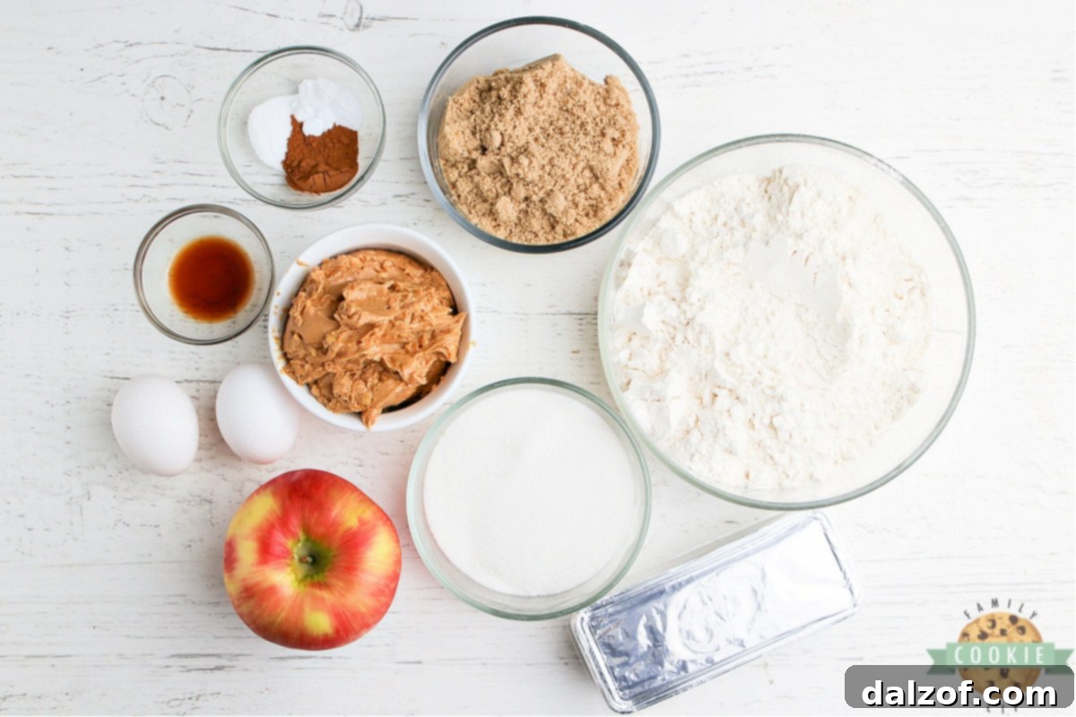 Assortment of fresh ingredients for baking Apple Peanut Butter Cookies laid out on a table.