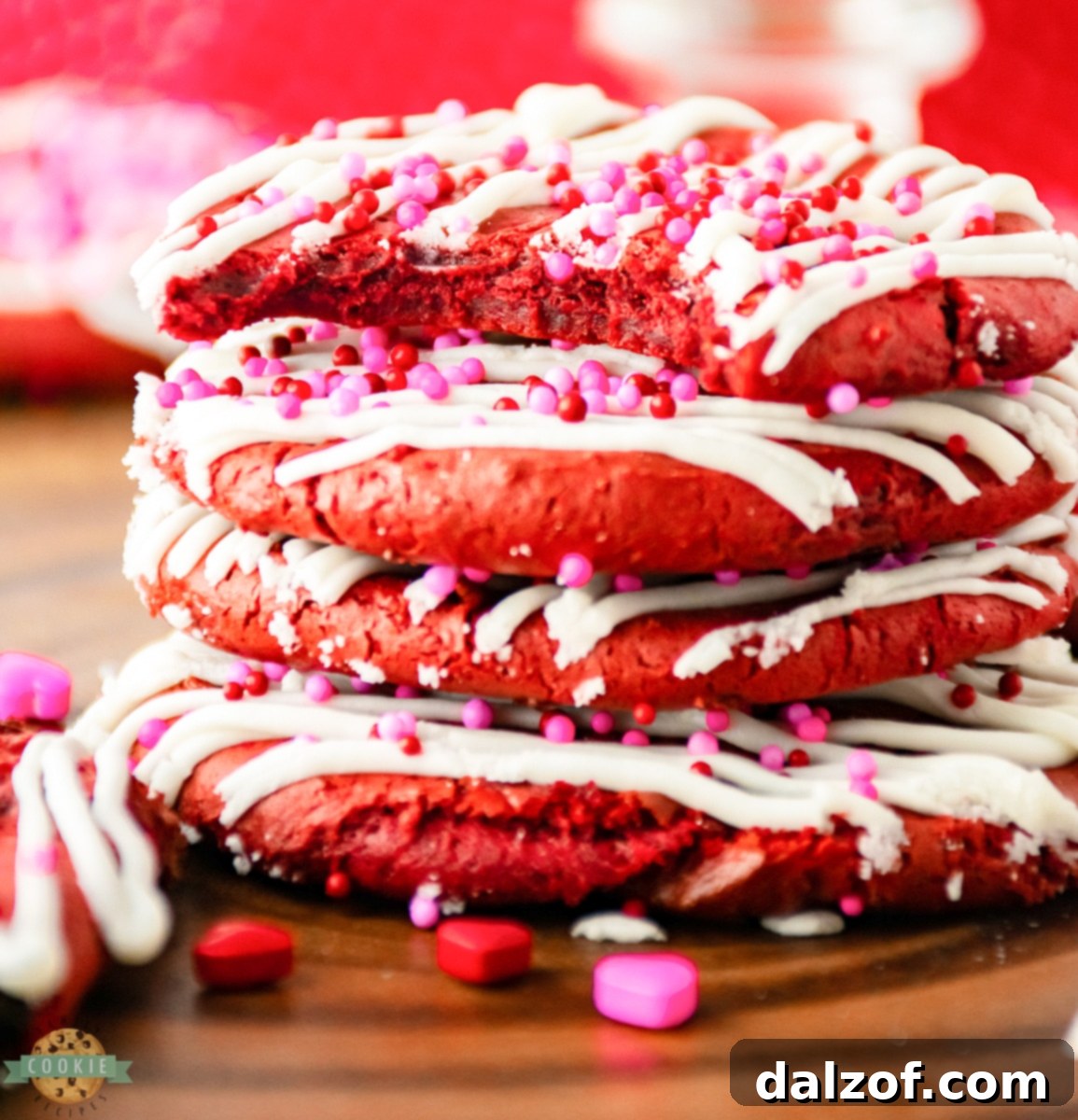 Effortless Red Velvet Valentine Cookies 2 Vibrant Red Velvet Cake Mix Cookies adorned with festive Valentine's sprinkles, set against a light background.