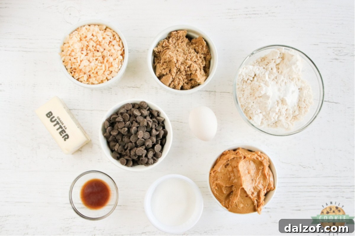 Peanut Butter Chocolate Crunch Cookies 4 A vibrant flat lay showcasing all the fresh ingredients required for Rice Krispie Chocolate Chip Peanut Butter Cookies, including butter, sugars, egg, vanilla, peanut butter, flour, baking soda, salt, Rice Krispies, and chocolate chips.
