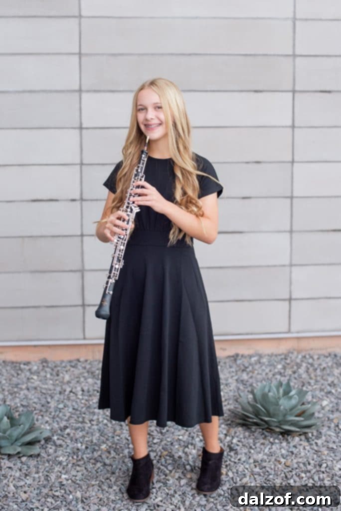 A proud mother shares a photograph of her talented daughter, a high school sophomore who plays both the oboe and saxophone, showcasing her musical journey.