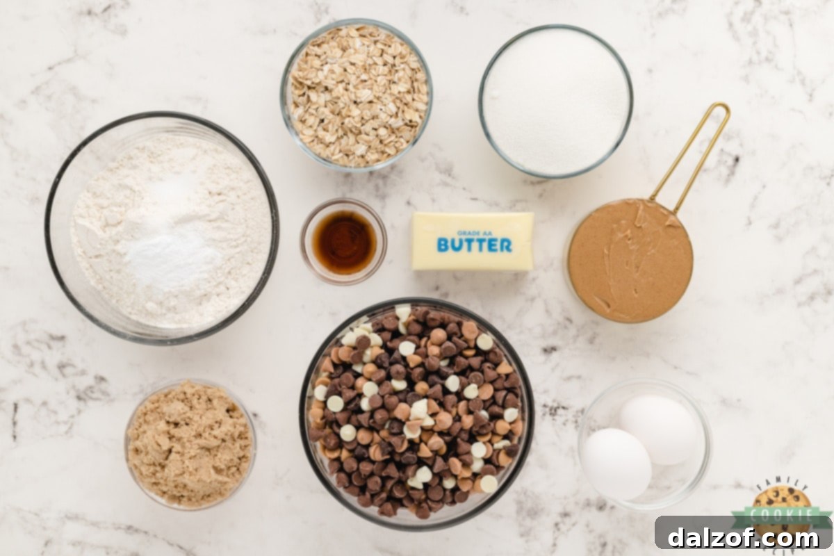 Various ingredients laid out for Five Chip Peanut Butter Oatmeal Cookies including butter, peanut butter, sugars, eggs, flour, oats, and five different types of baking chips