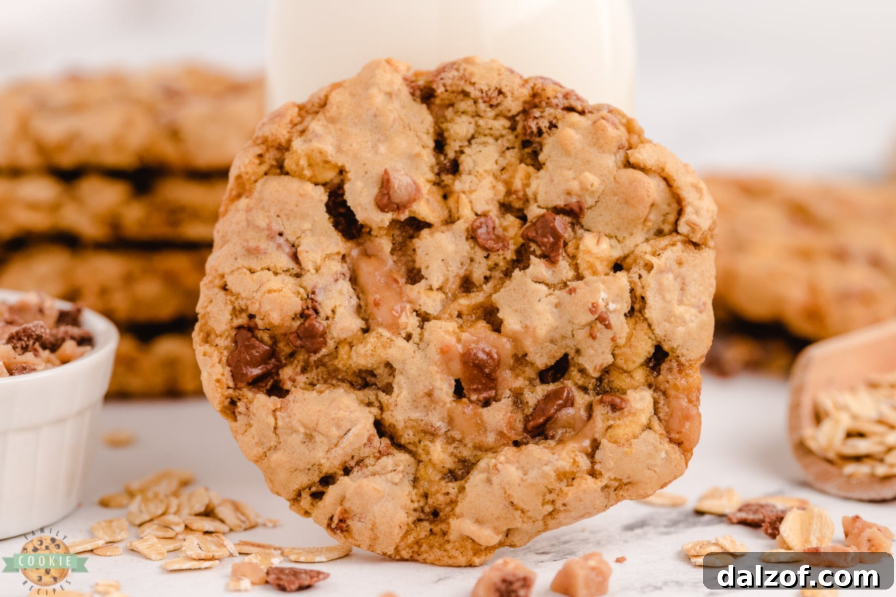 single toffee oatmeal cookie with a bite taken out, showing chewy texture and toffee bits