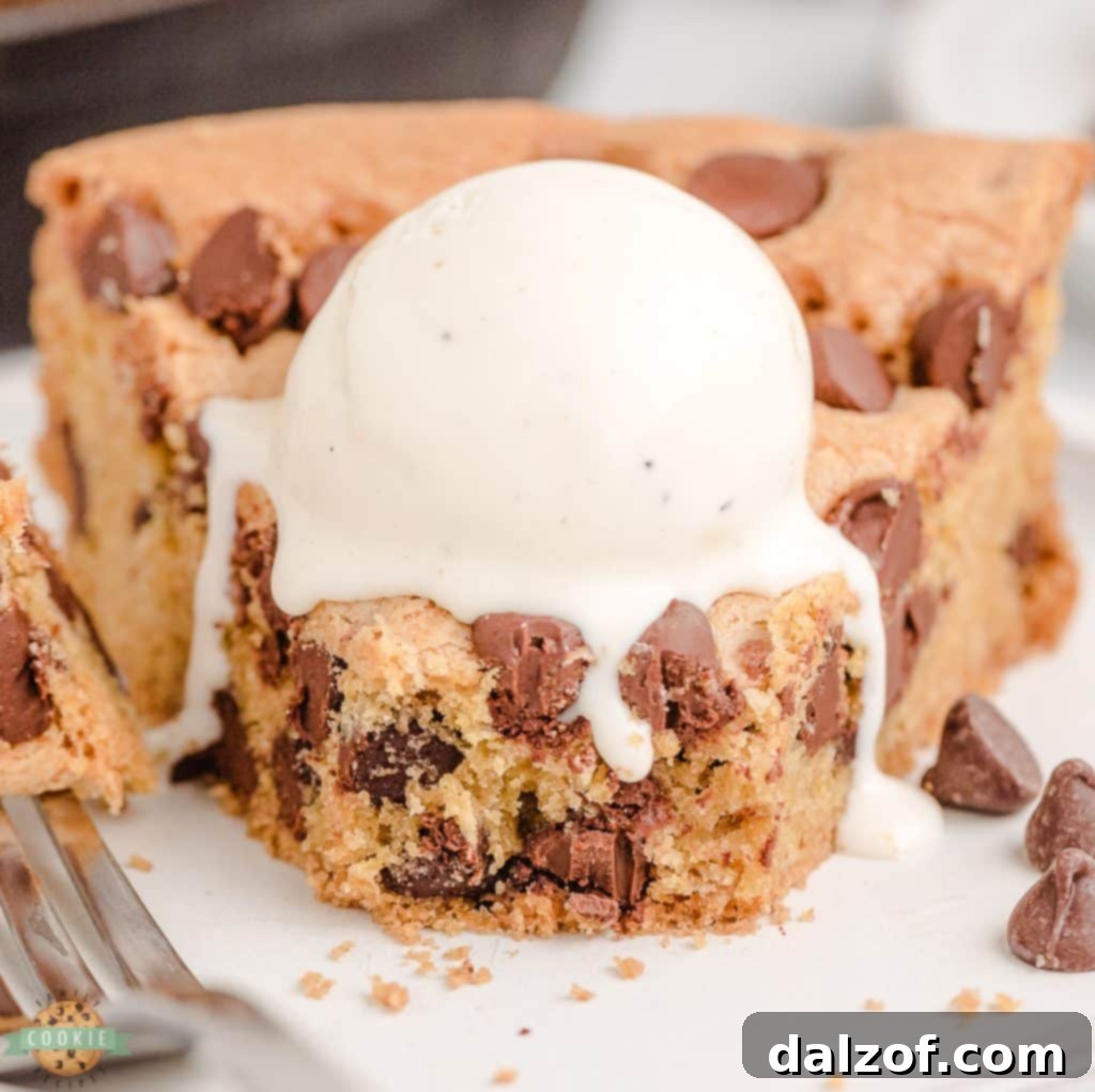 Slice of cast iron skillet cookie with ice cream.