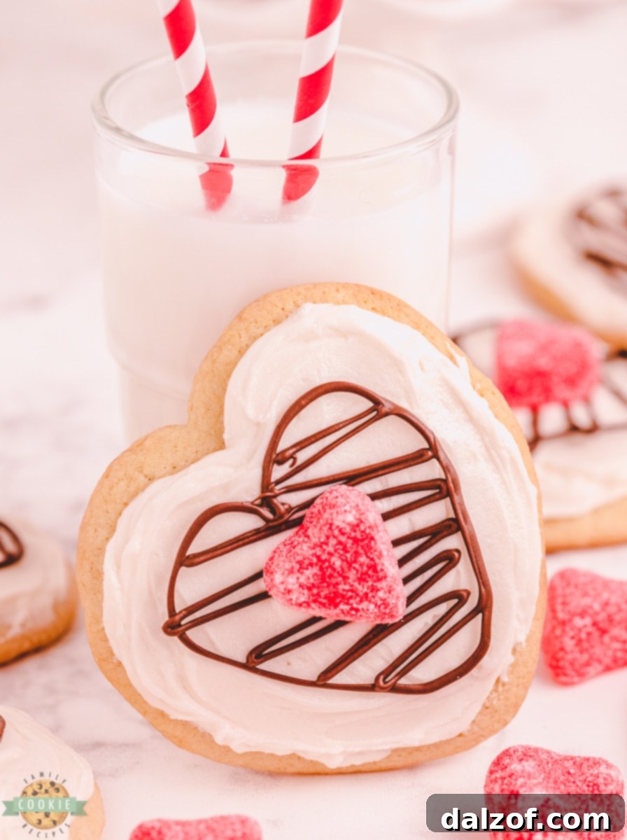 Valentine's Day cookies with chocolate hearts, adorned with intricate chocolate lattice designs, resting on a white platter.
