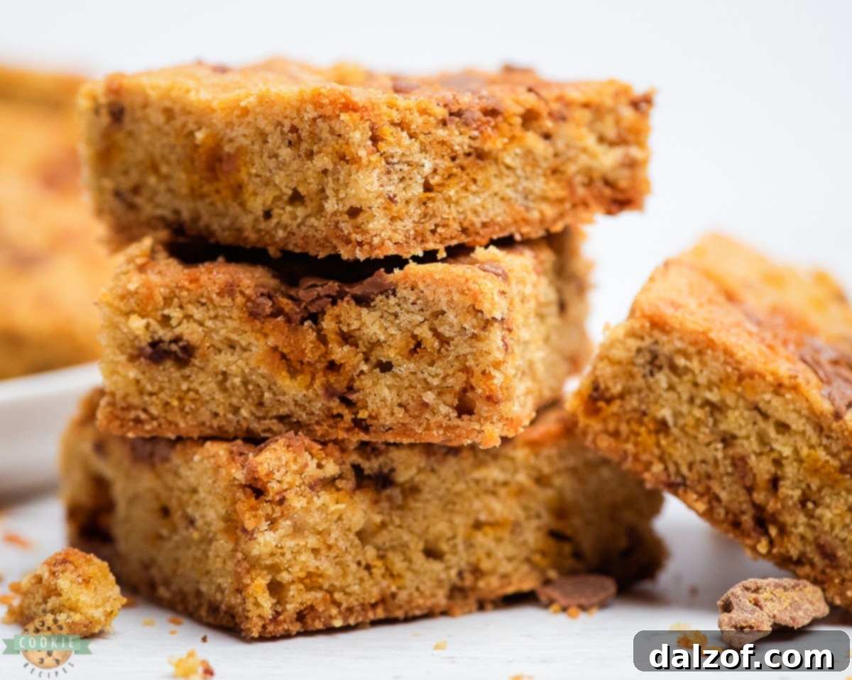 Close-up of baked Butterfinger cookie bars, showing their crispy texture