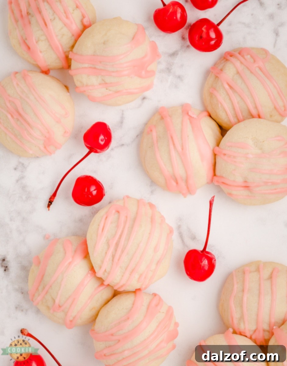 Various Cherry Shortbread Cookies displayed on a baking sheet and cooling rack
