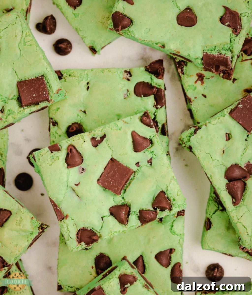 Close-up of vibrant green mint chocolate chip cookie bars with melted chocolate chips