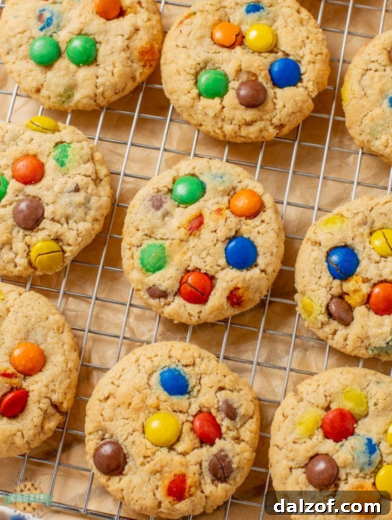 Freshly baked M&M cookies cooling on a wire rack, perfectly golden and studded with colorful candies.