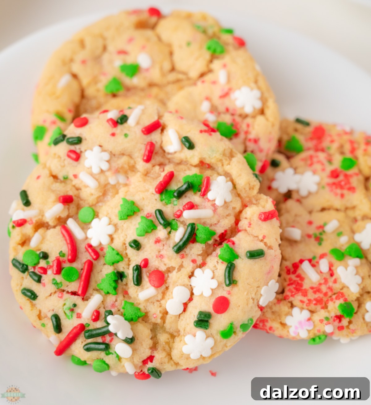 Christmas Sprinkle cookies on a white plate, showcasing their festive colors and soft texture.