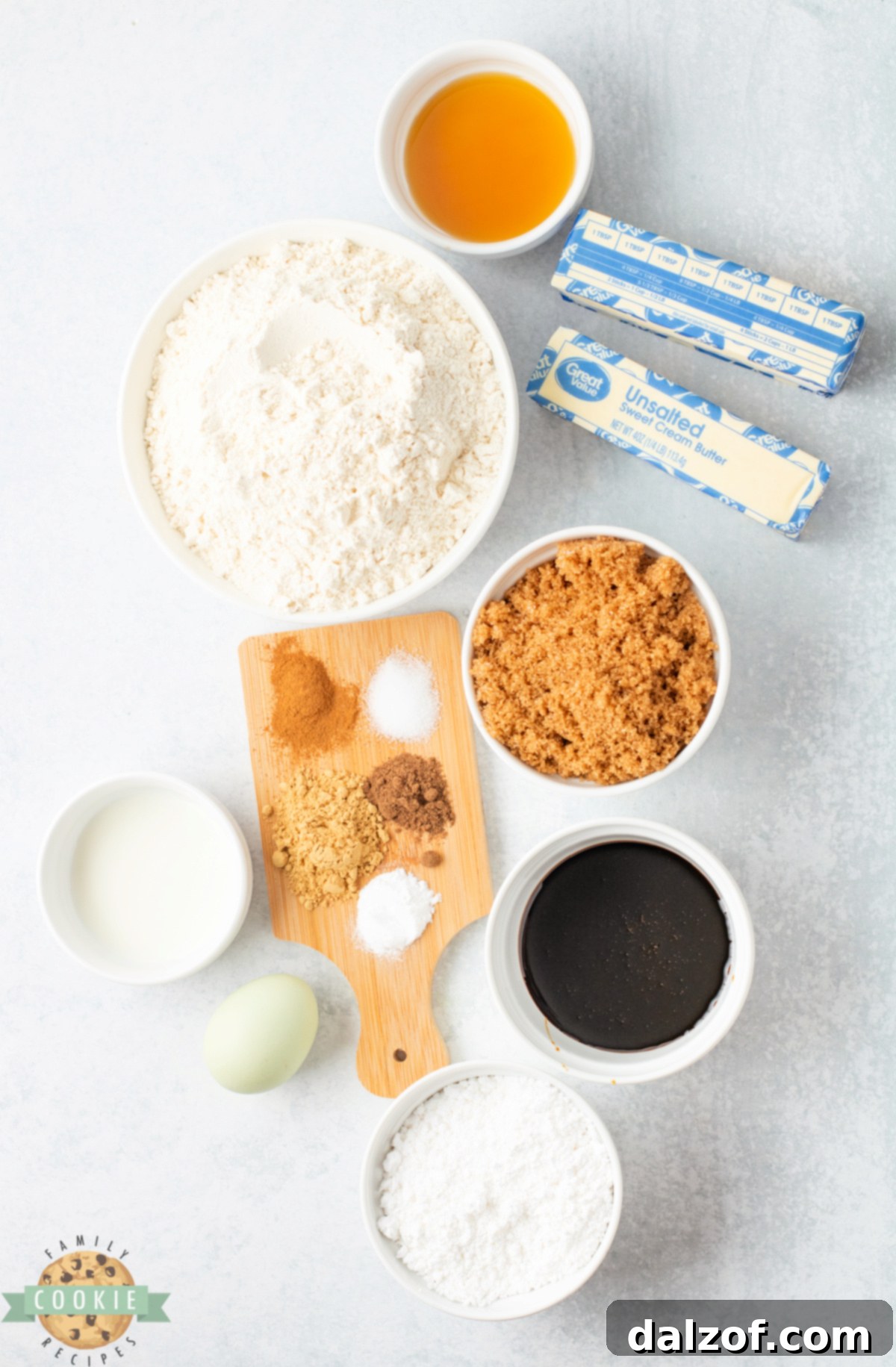 All the essential ingredients laid out for baking Gingerbread Cookies with Maple Icing, including flour, spices, molasses, butter, and maple syrup.